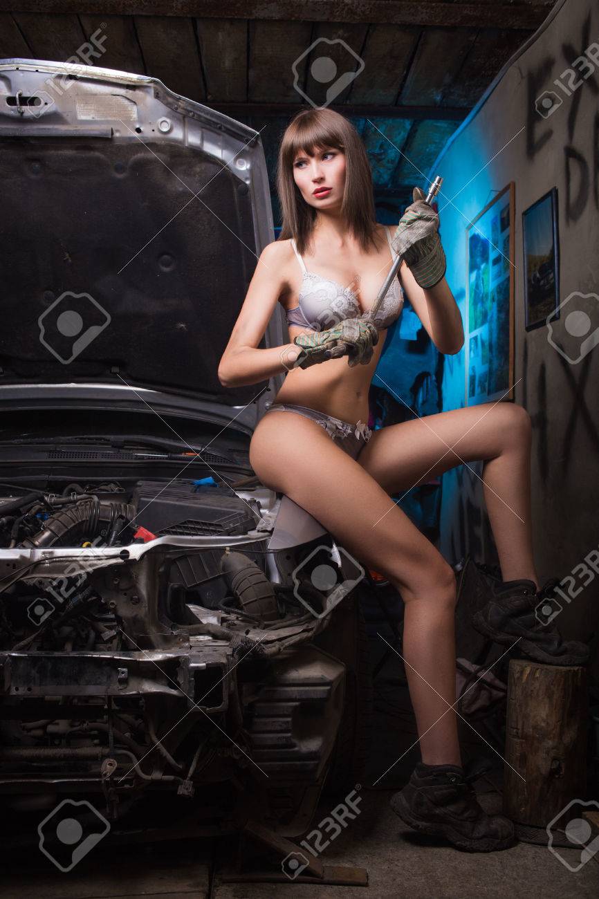 25607773-Girl-in-the-garage-with-the-tools-in-heavy-boots-and-underwear-Stock-Photo.jpg