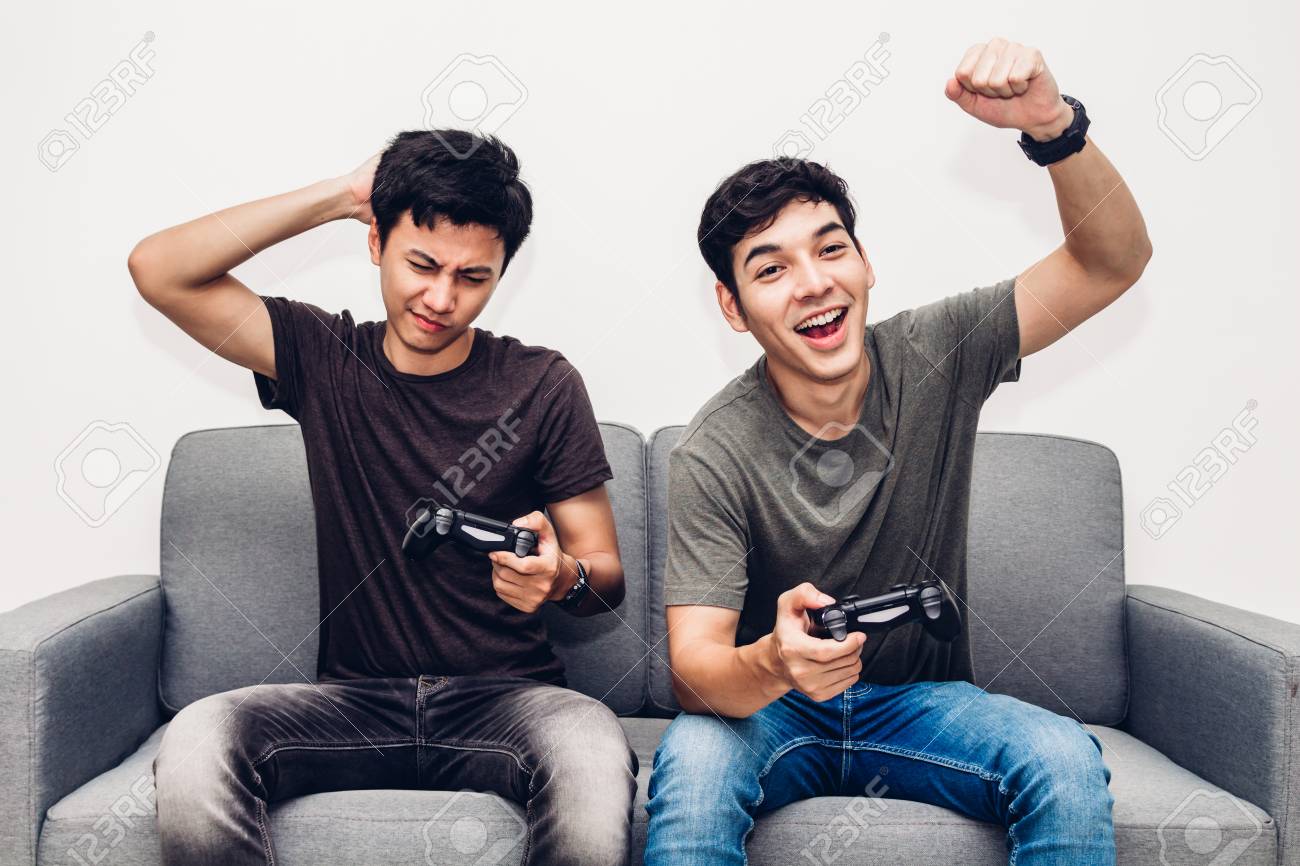108531159-two-friends-sitting-on-sofa-and-enjoying-play-video-game-together-at-home.jpg